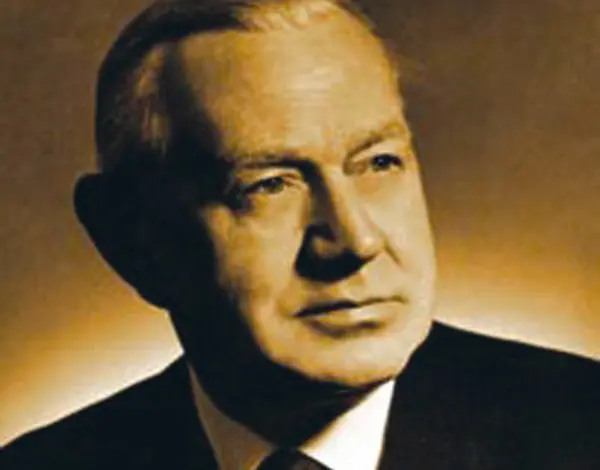 Sepia-toned portrait of an older man in a suit looking off to the side.