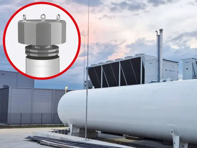 Large white horizontal storage tank at an industrial site with a circular inset highlighting a close-up of a metallic pressure or vent valve component.
